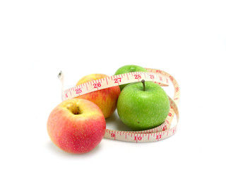 measuring tape wrapped around a green apple for diet