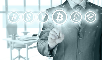 Choosing bitcoins, businessman pressing touch screen button.