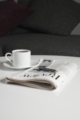Coffee cup and newspaper