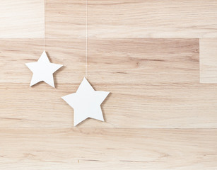 Fototapeta na wymiar handmade paper stars isolated on wooden background with shadow