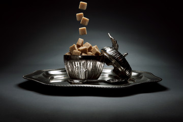 Silver sugar container on metallic tray
