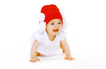 Positive baby in red hat crawls