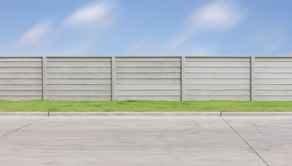 Fototapeta na wymiar Prefabricated or precast concrete fence. Consist of panel and column as border or boundary offer security, privacy for residential. Including empty space on road floor paving with concrete pavement.