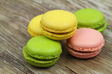 Colorful macaroons on wooden surface