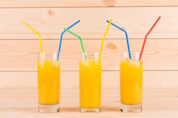 Orange juice on wooden table.