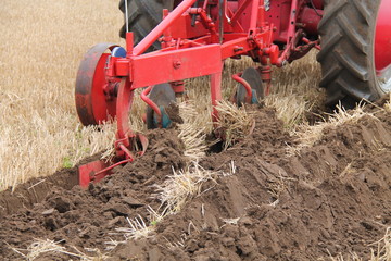 A Vintage Plough Cutting a Deep Furrow in a Field.