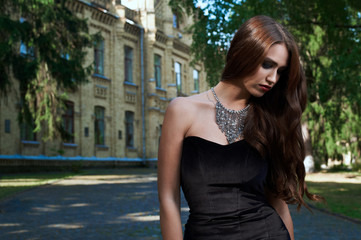 sexy woman in black dress and necklace