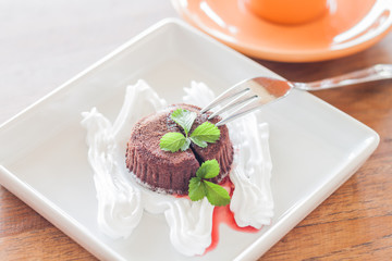 Chocolate lava on white plate and coffee cup