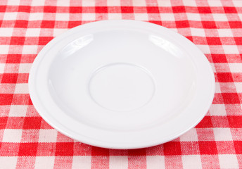 White clean plate on a red-white vichy tablecloth - 70510831