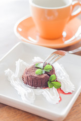 Chocolate lava cake with fork and coffee cup