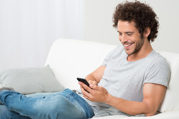 Smiling Young Man Holding Cellphone
