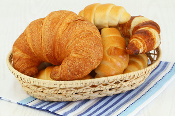 Butter croissants in bread basket, close up