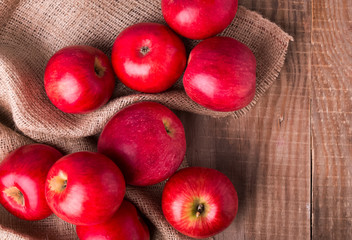 Red apples on the wooden table