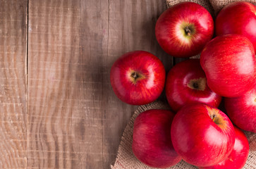 Red apples on the wooden table
