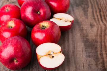 Naklejka na ściany i meble Red apples on the wooden table