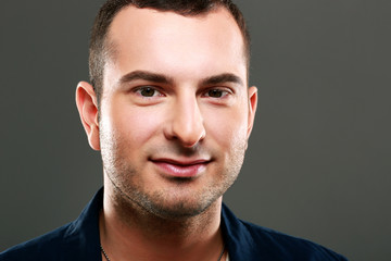 Obraz premium Closeup portrait of happy man on gray background