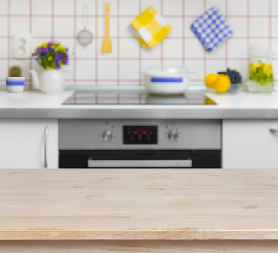 Wooden table on blurred background of kitchen bench