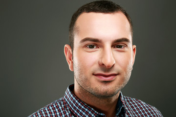 Fototapeta premium Closeup portrait of happy man on gray background