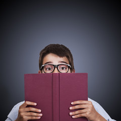 child at the table with books from school