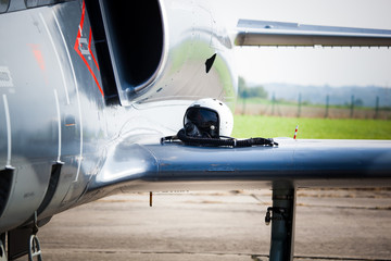 Detail of military fighter/interceptor/jetplane jet engine and wing with pilot's oxygen mask and...