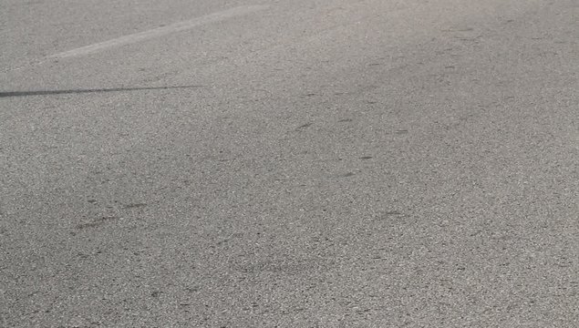 footrace in asphalt road with athletes in sneakers