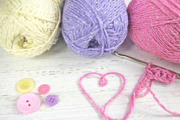 Yarn Wool pastel colours with crochet hook heart and buttons