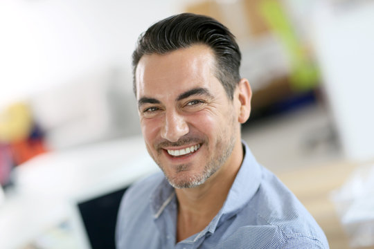 Portrait of cheerful businessman in office
