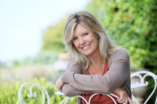 Portrait of smiling mature blond woman in garden
