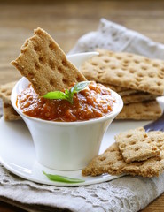 vegetable ragout dip from eggplant and tomato with crisps © Olga Kriger