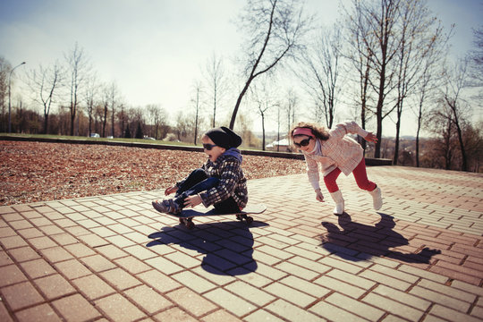 boy and girl skating on the street