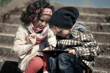 little girl and boy playing outdoor