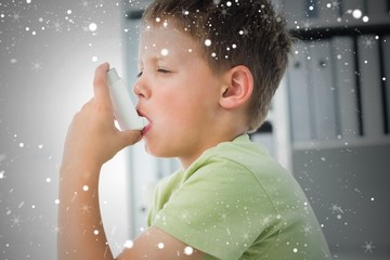 Boy using an asthma inhaler in clinic - obrazy, fototapety, plakaty