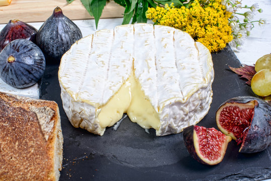 Camembert cheese on a plate slate