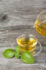 Pouring tea into cup of tea