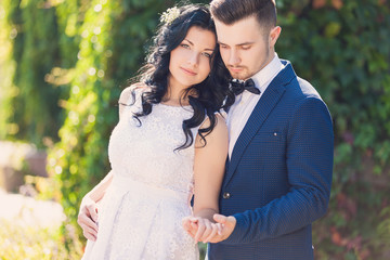 Wedding shot of bride and groom in green park