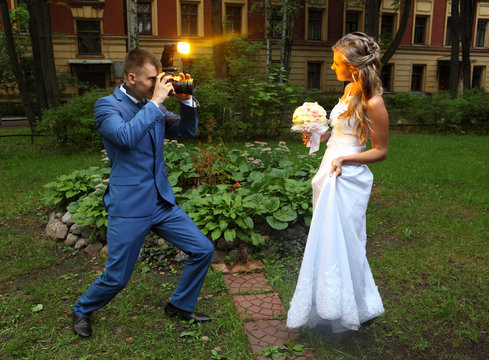 Wedding Photographer Taking Picture bride, camera flash flashing