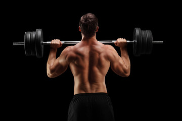 Studio shot of a bodybuilder lifting a barbell