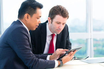 Businessmen working together in office