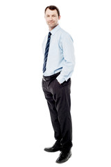 Confident businessman with hands in pockets