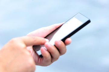 woman hands use cell phone outdoor 