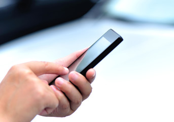 woman hands use cell phone outdoor 