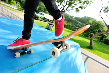 skateboarding woman legs at skatepark 