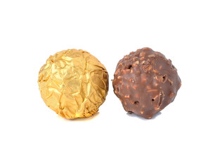 Sweet chocolate candy wrapped in golden foil isolated on white b