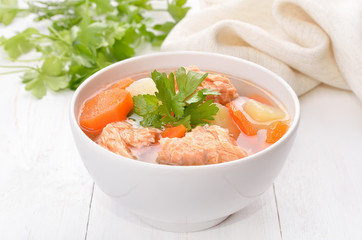 Fish soup with salmon in bowl