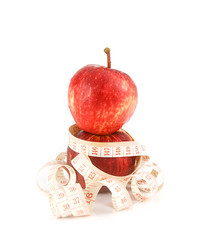 fresh red  juicy  apples fruit and measure tape  on white backgr