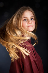 Fototapeta premium Scandinavian cute young girl portrait with hair in movement