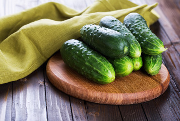 Fresh cucumbers on wooden background