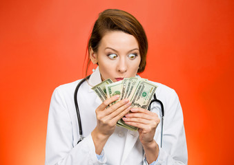 Greed. Crazy looking female healthcare professional with money