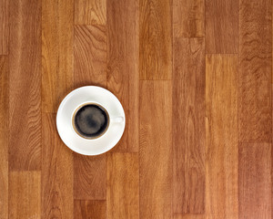 White cup of coffee on wooden table.