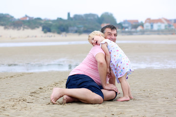 Fototapeta na wymiar Father with daughter having fun on the beach